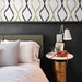 NextWall Peel &amp; Stick Ogee Ribbon Metallic Gold &amp; Ebony Wallpaper thumbnail image 5 of 5